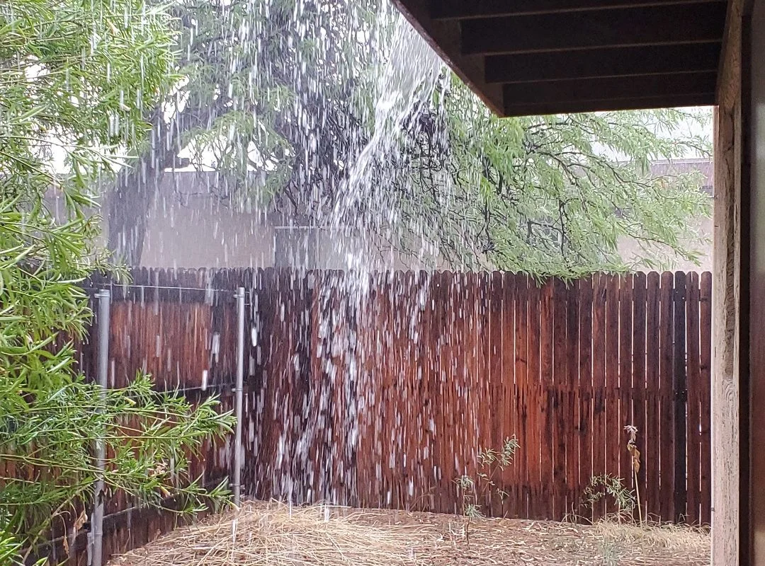 Monsoon rain sheeting off roof in Tucson